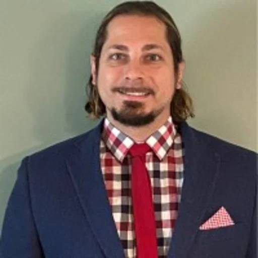 Andrew Sellers smiling in a suit